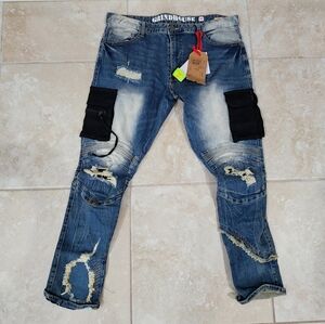 Brand-Grind House-Distressed blue denim jeans with black patches and knee rips
